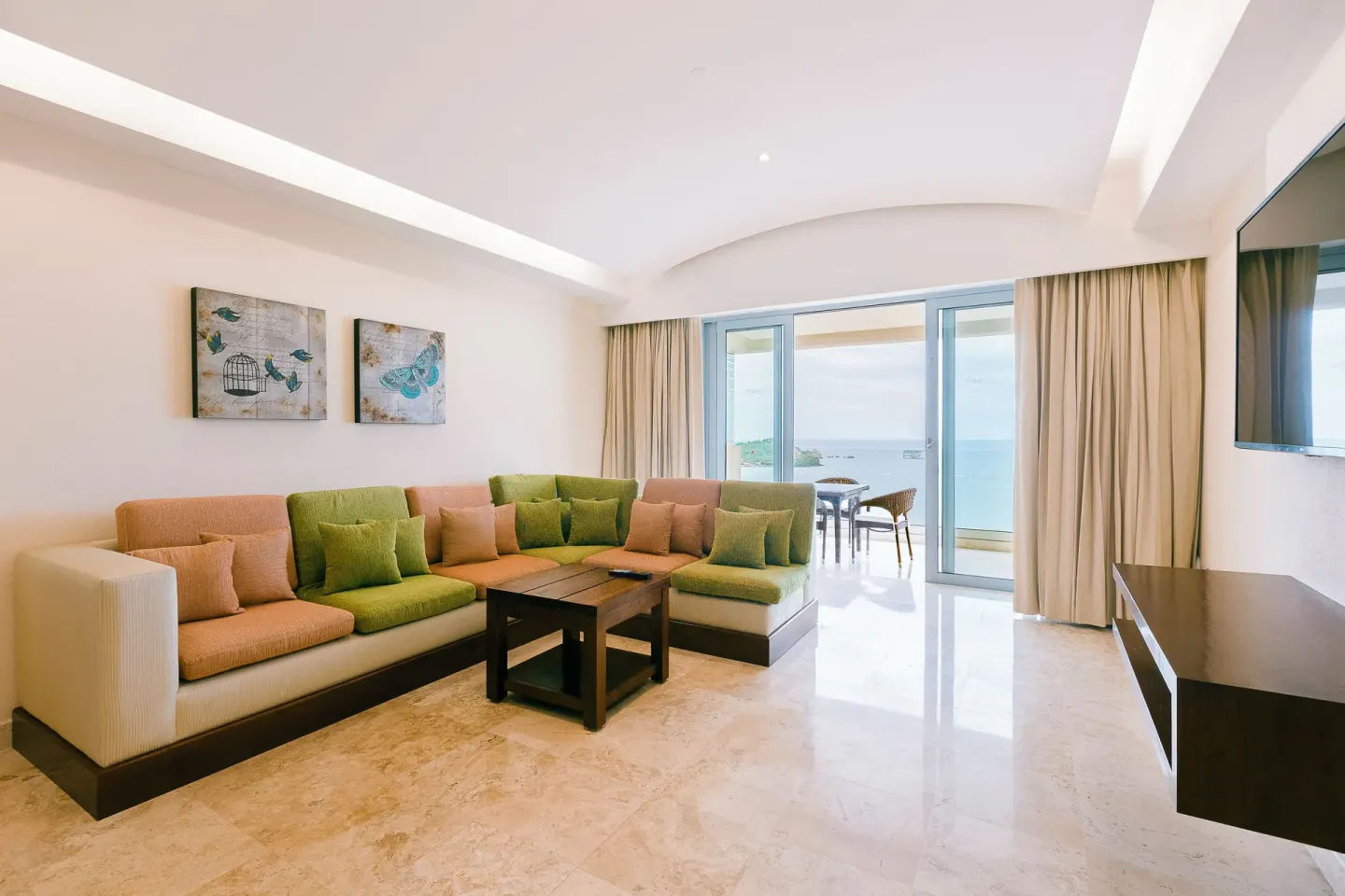 Master Suite living room with sectional sofa and ocean-facing balcony at Hotel Azul Ixtapa Grand Resort Spa.