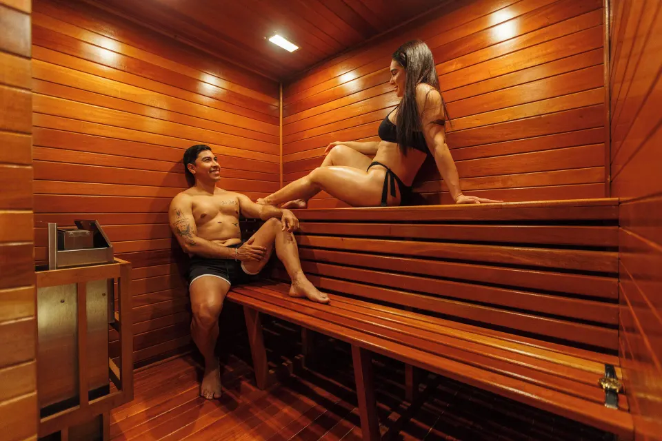 Wood-lined sauna with two guests in the Master Suite at Hotel Azul Ixtapa Grand Resort Spa.