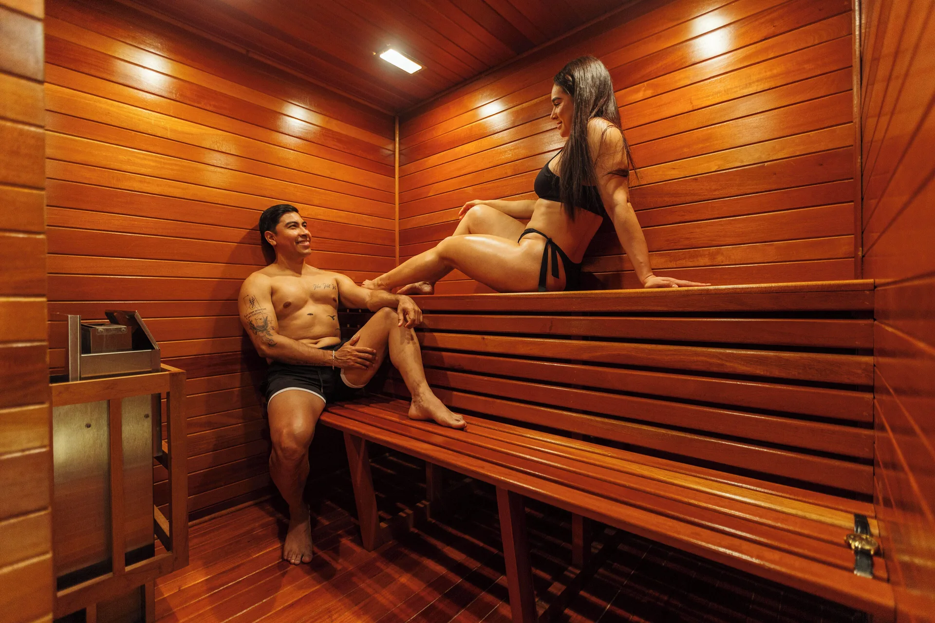 Wood-lined sauna with two guests in the Master Suite at Hotel Azul Ixtapa Grand Resort Spa.