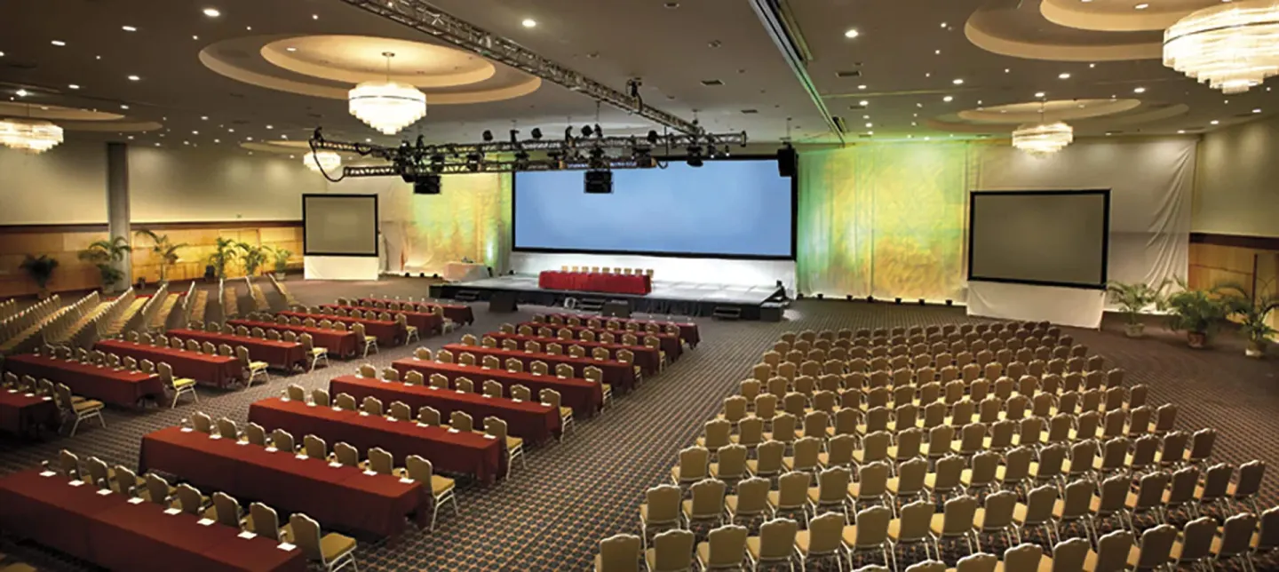 Large conference hall with stage screens and rows of seating at Hotel Azul Ixtapa Grand Resort Spa.