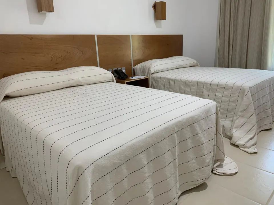 Standard room with two double beds and bedside phone at Hotel Castillo Huatulco & Beach Club.