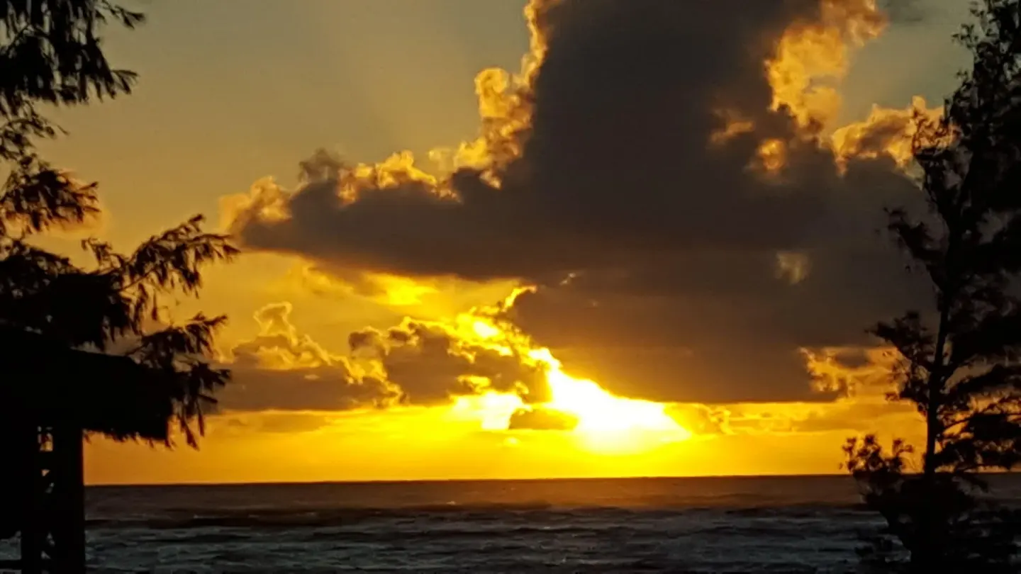 Golden sunset clouds over the ocean at Hotel Coral Reef.