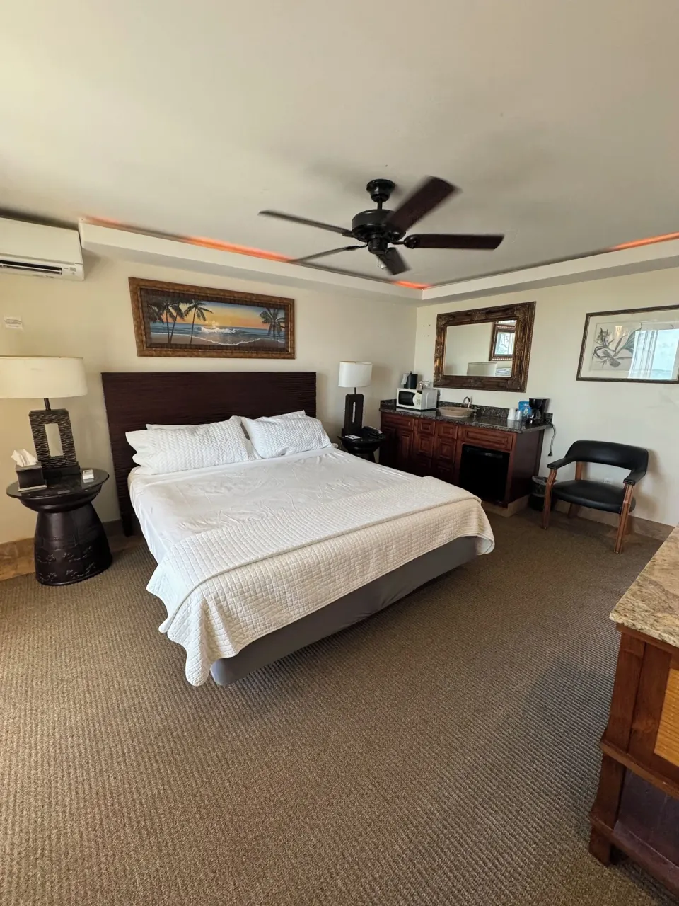 Panoramic Room with king bed, vanity, ceiling fan, and seating at Hotel Coral Reef.