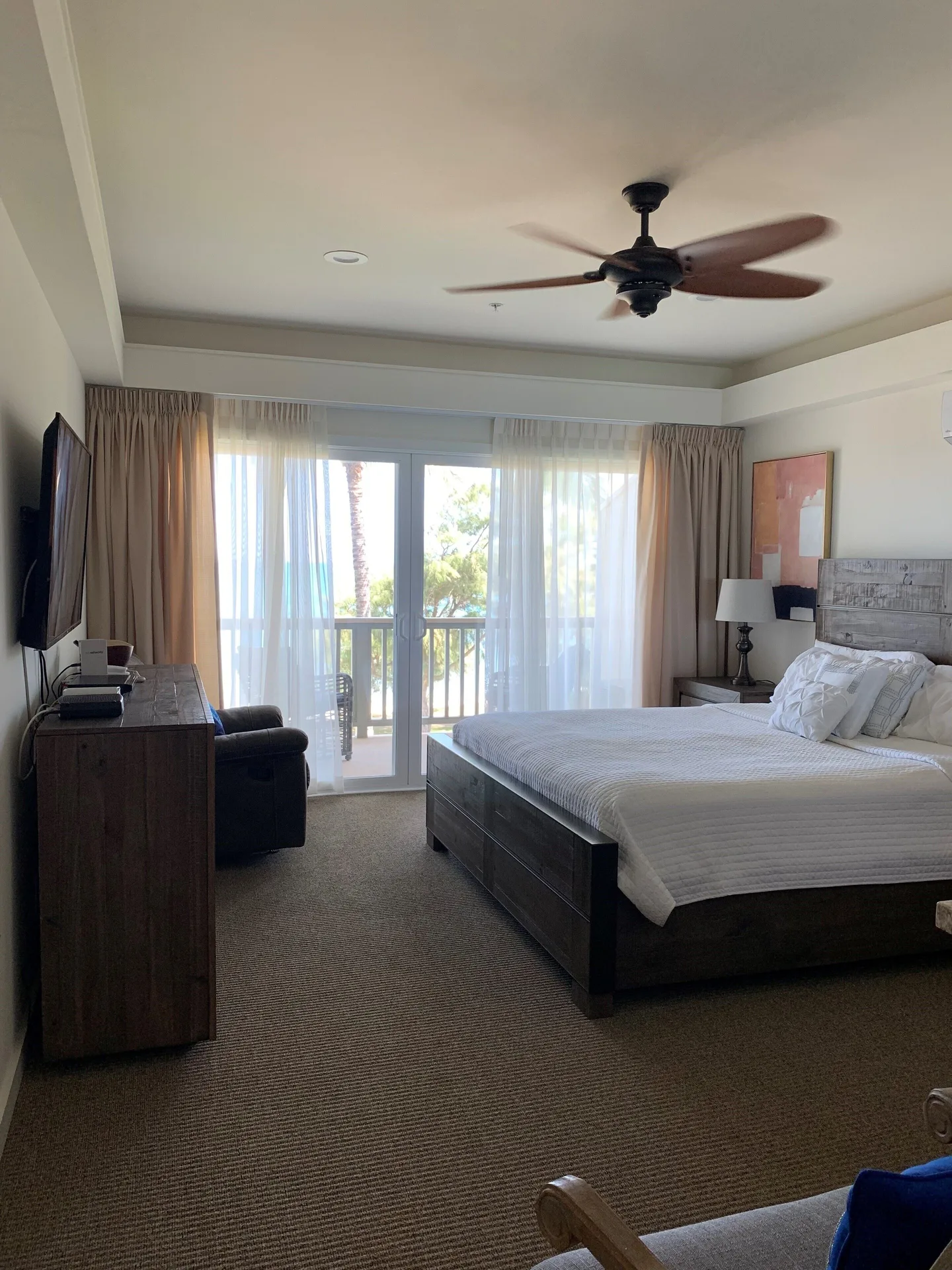 Premium Room Oceanfront king bed and balcony doors at Hotel Coral Reef.
