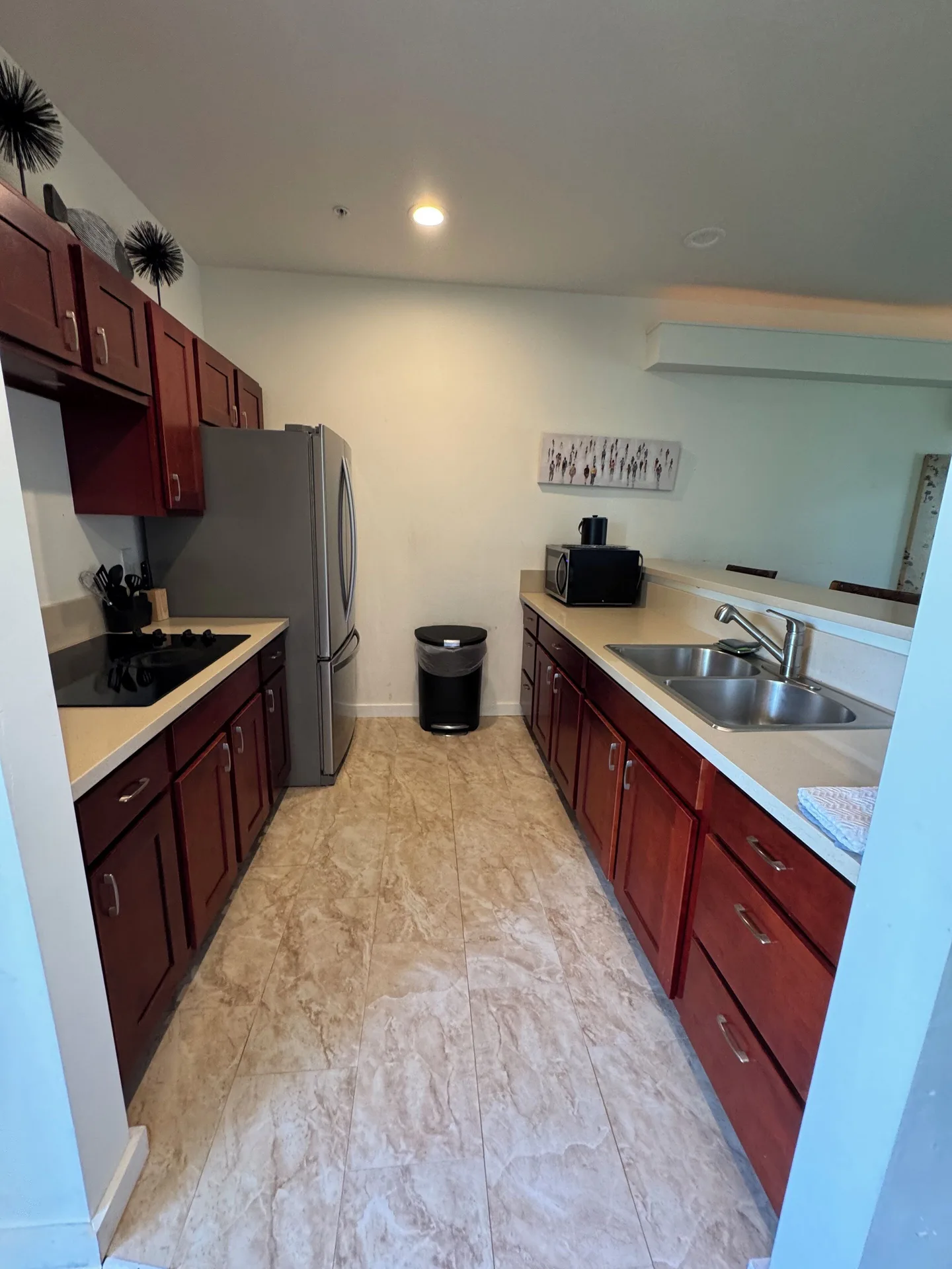Premium Suite kitchen with refrigerator, sink, cabinets and microwave at Hotel Coral Reef.