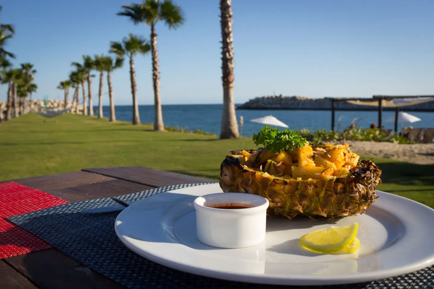 Pineapple seafood dish on an outdoor table by the water at Hotel El Ganzo.