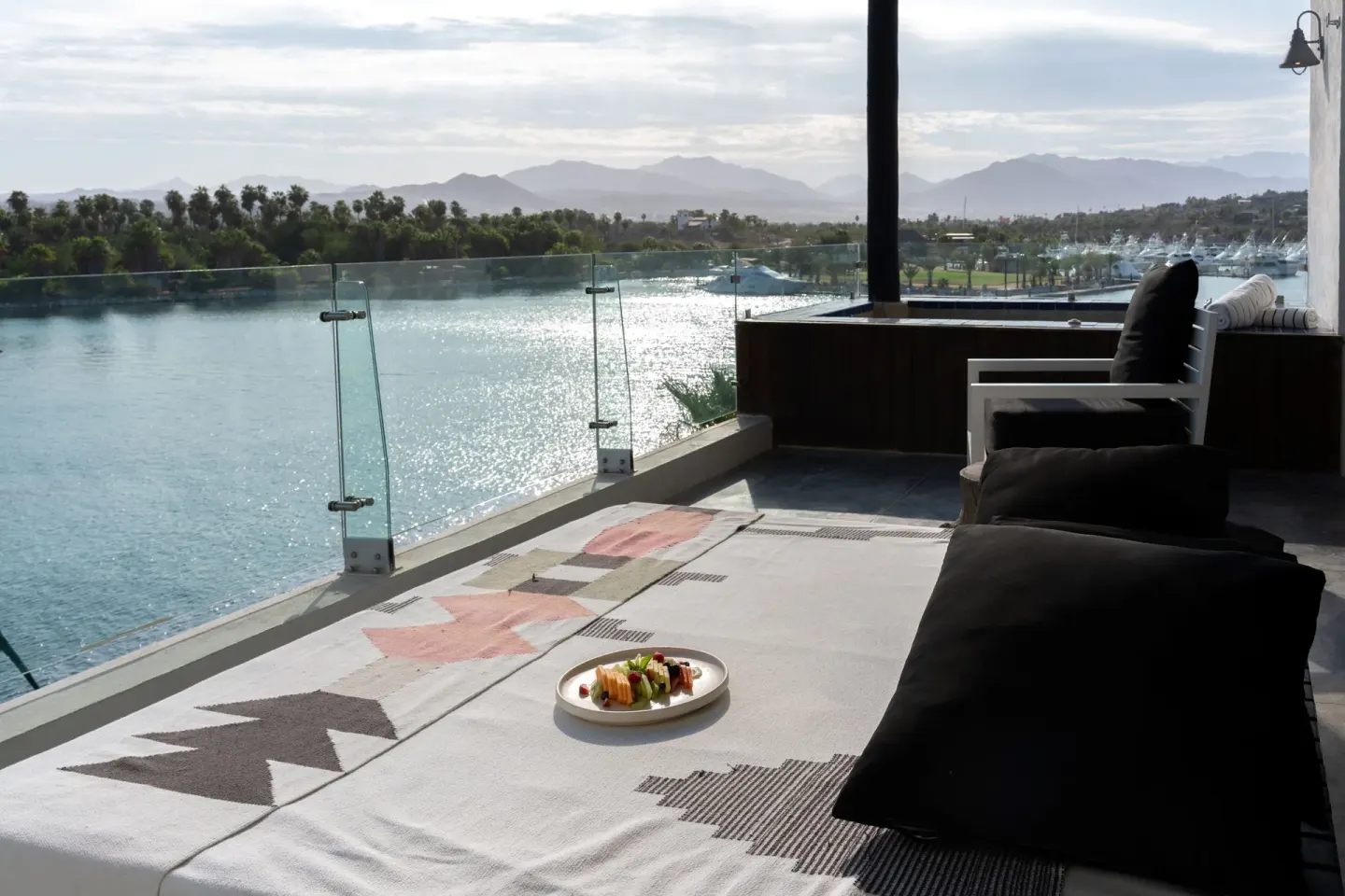 Captain's Suite terrace daybed with water and mountain view at Hotel El Ganzo.