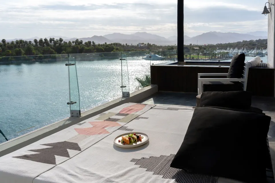 Captain's Suite terrace daybed with water and mountain view at Hotel El Ganzo.