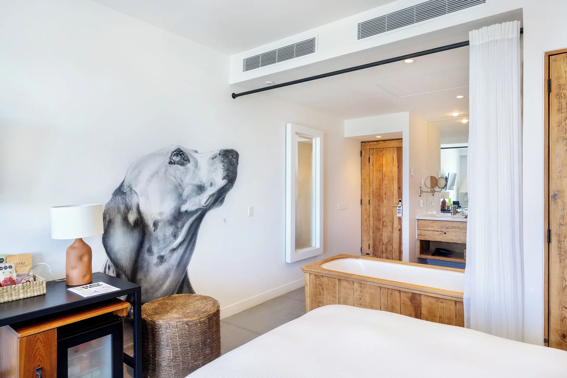 Oceanview Balcony Room at Hotel El Ganzo with unique dog mural, tub, and balcony access in San José del Cabo.
