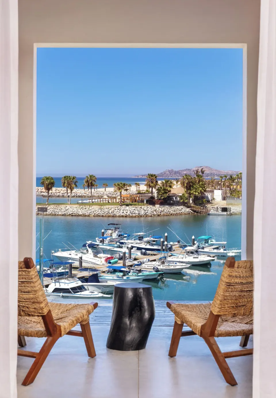 Standard Suite One Bedroom balcony seating with marina and ocean view at Hotel El Ganzo.