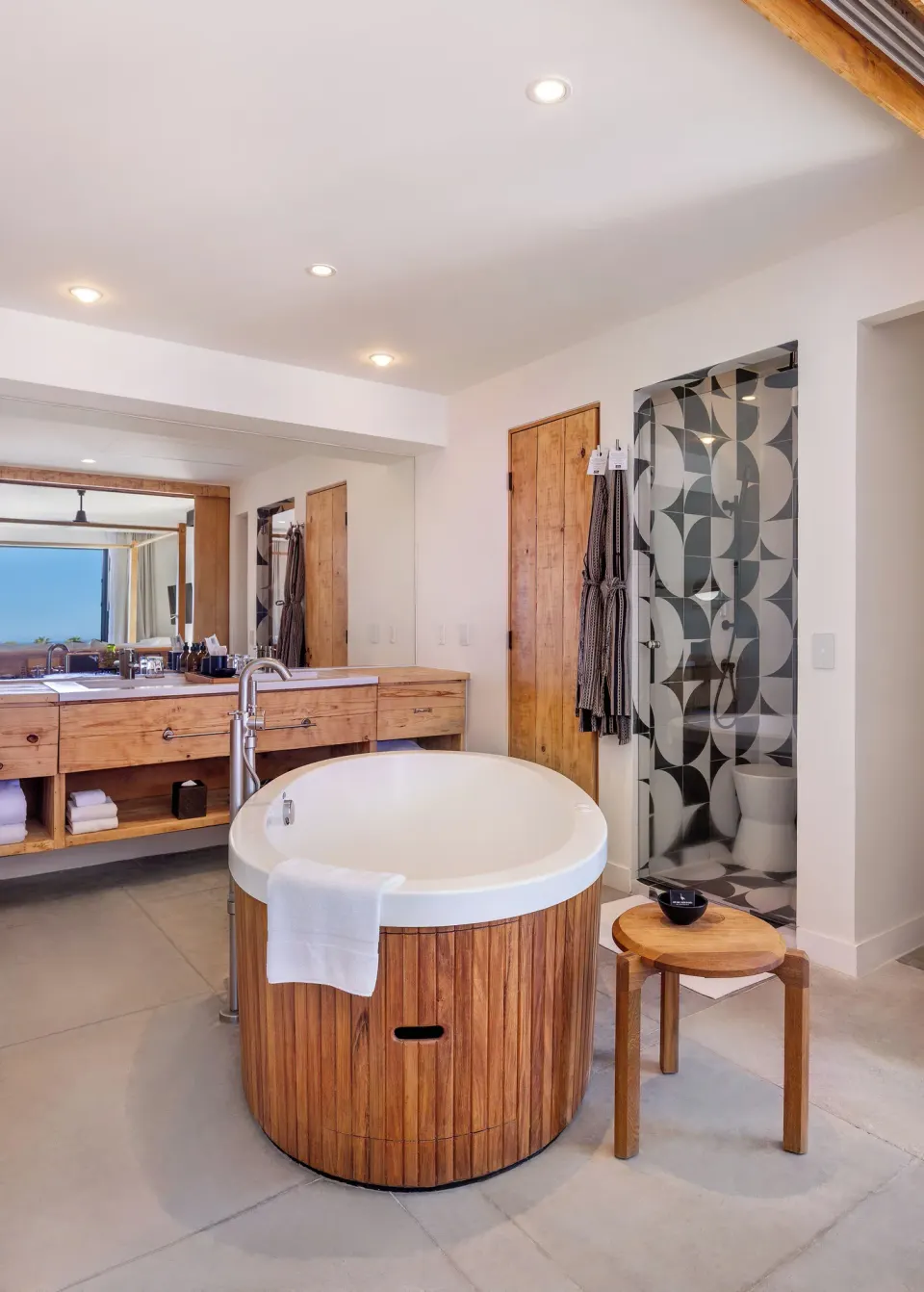 Standard Suite bathroom with round soaking tub and patterned shower at Hotel El Ganzo.