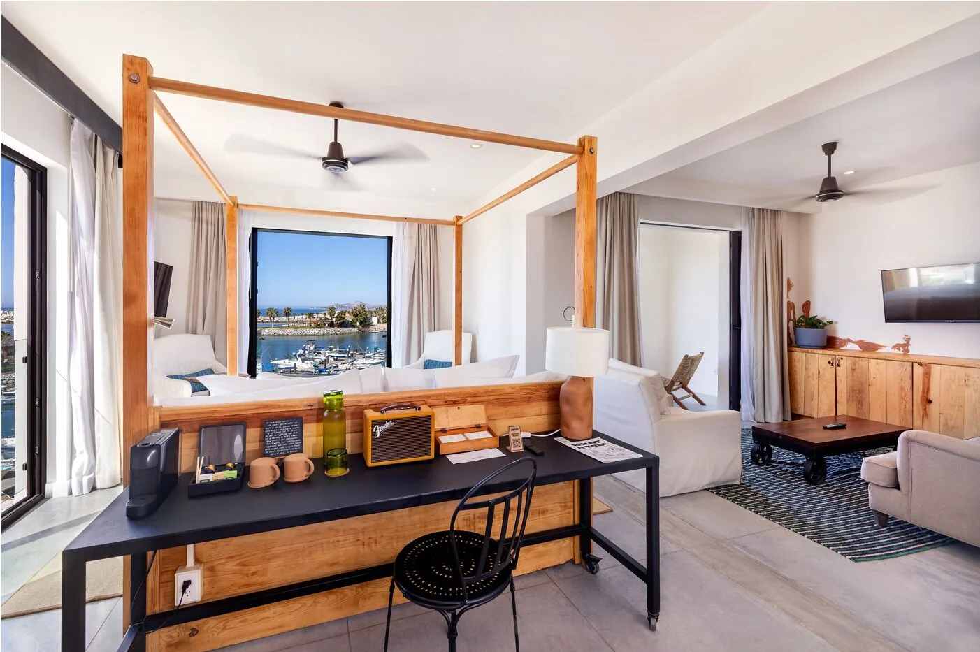 Standard Suite with four-poster bed, desk, and living area at Hotel El Ganzo.