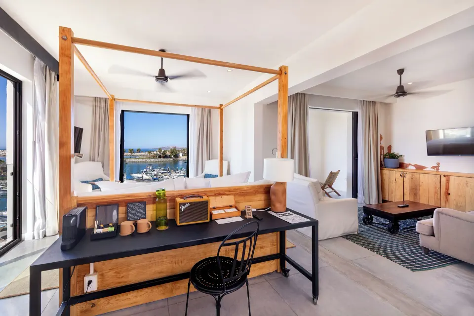 Standard Suite with desk, four-poster bed, and lounge area at Hotel El Ganzo.