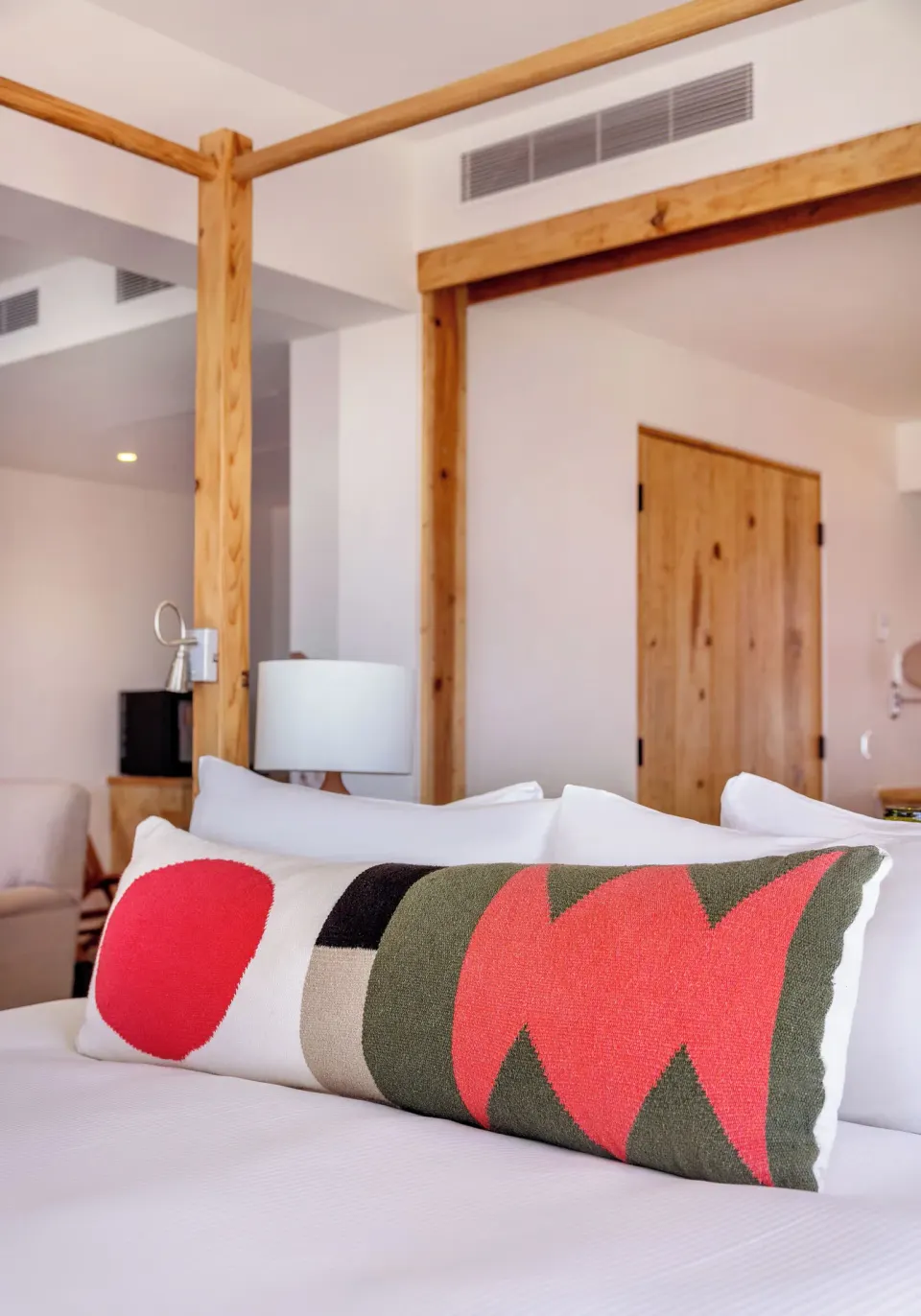 Standard Suite One Bedroom bed pillows and wood frame at Hotel El Ganzo.