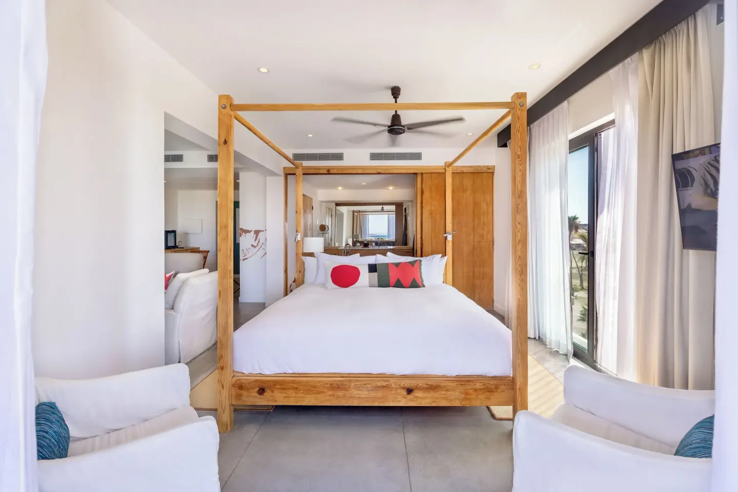 Standard Suite One Bedroom king bed with seating and balcony doors at Hotel El Ganzo.