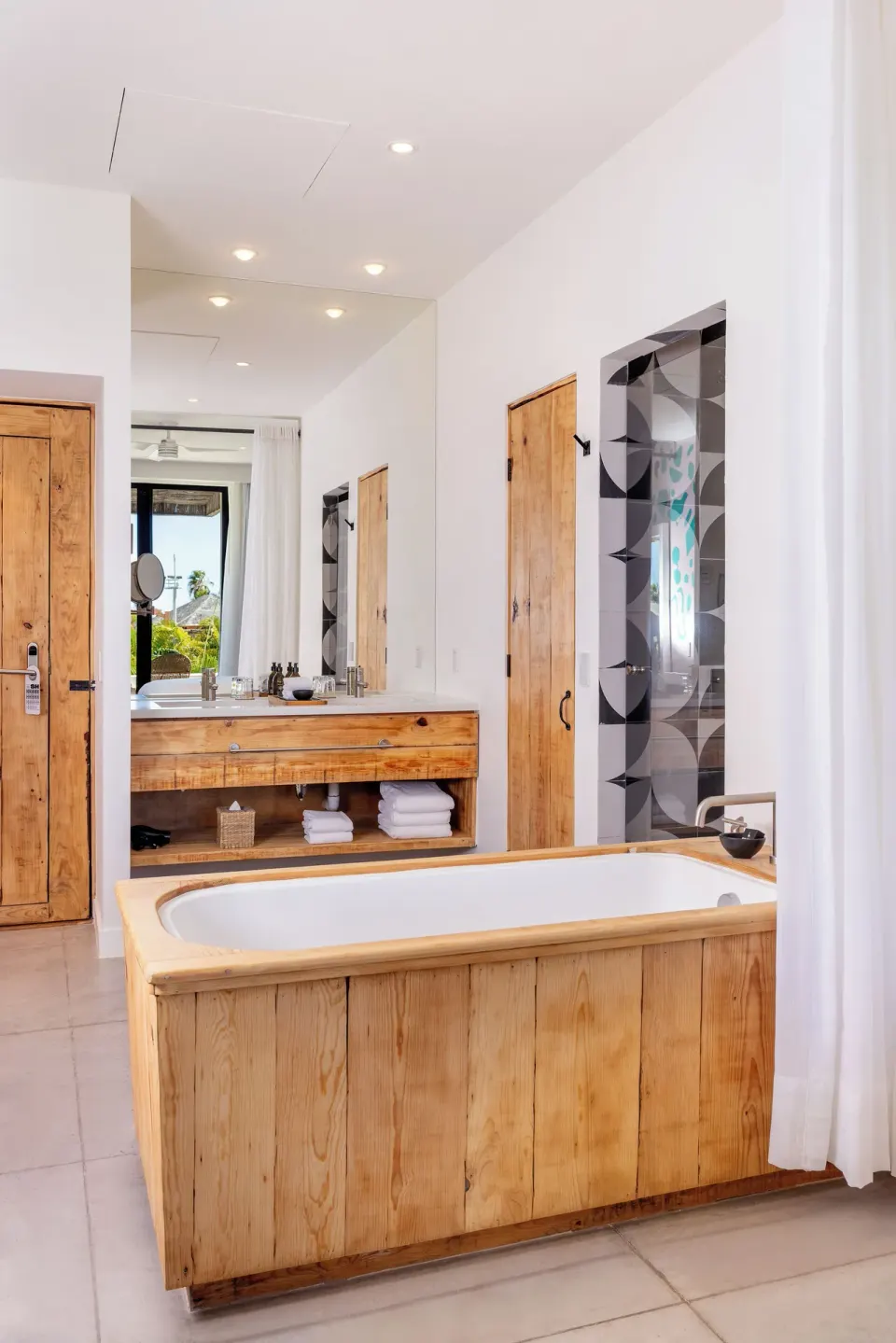 Terrace Two Beds bathroom at Hotel El Ganzo with a wood-paneled tub and double vanity.