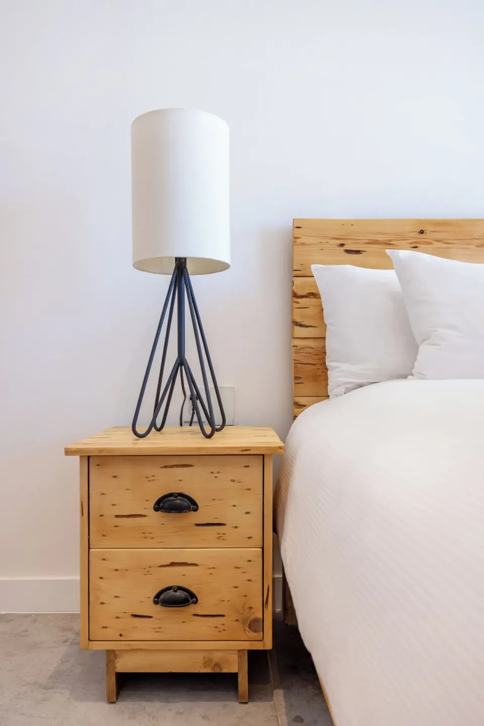 Terrace Two Beds bedside detail at Hotel El Ganzo with a wood nightstand and white bedding.