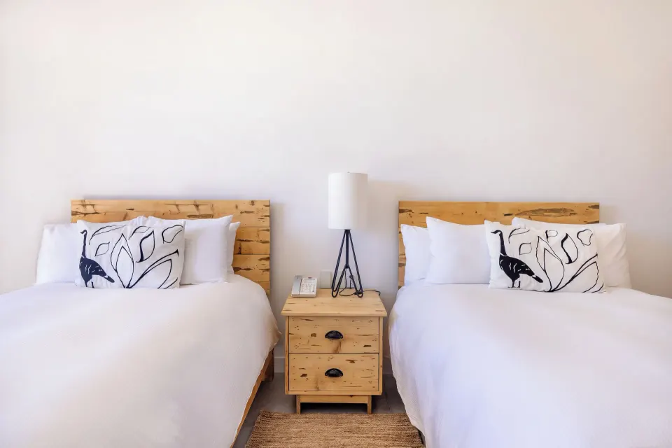 Terrace Two Beds guest room at Hotel El Ganzo with two white beds and wood headboards.