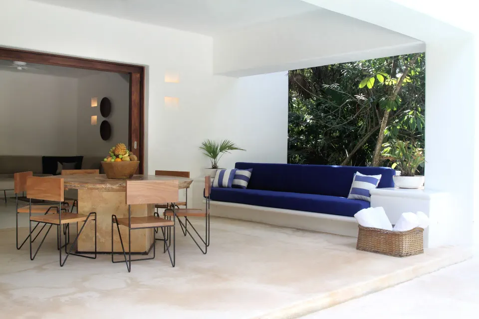 Bright white suite with canopy bed and freestanding tub at Hotel Esencia.
