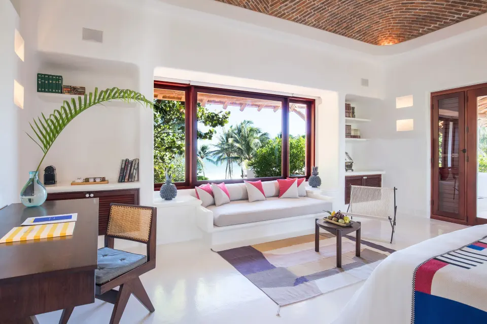 Suite living area with built-in sofa and sea view at Hotel Esencia.