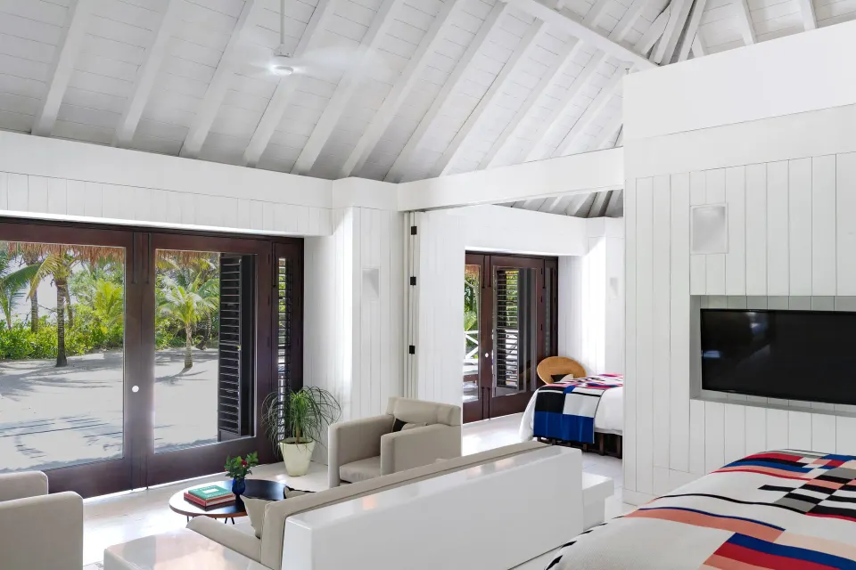Open-plan suite with vaulted ceiling and sliding doors to the sand at Hotel Esencia