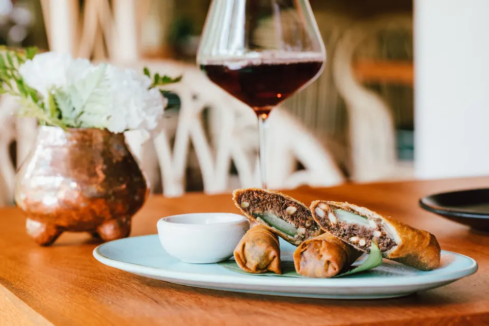 Crispy stuffed rolls with dipping sauce and wine at Hotel Esencia