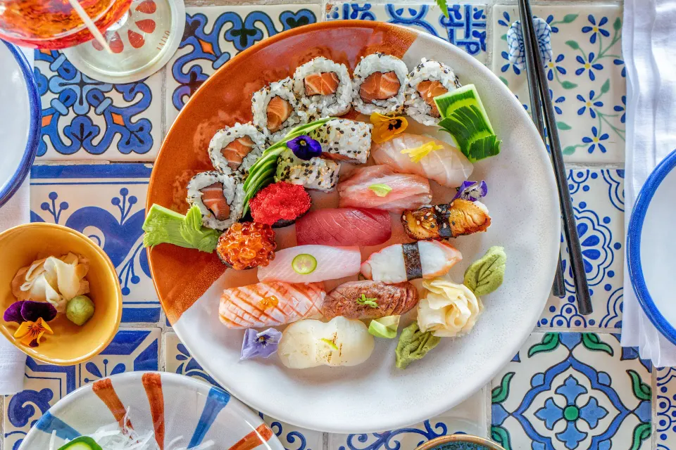 Top-down sushi plate with rolls and nigiri at Hotel Esencia