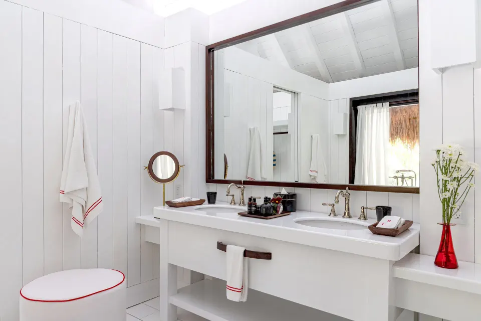 Double sink vanity and large mirror in the Presidential Bungalow bathroom at Hotel Esencia