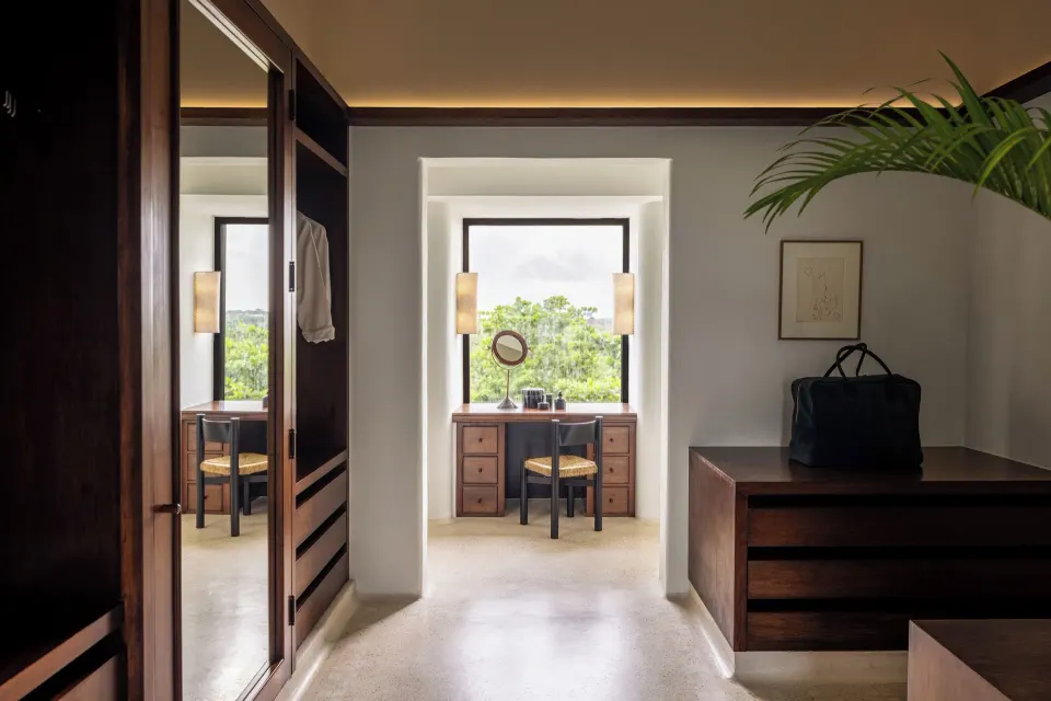 Dressing area with vanity and wardrobes in suite at Hotel Esencia