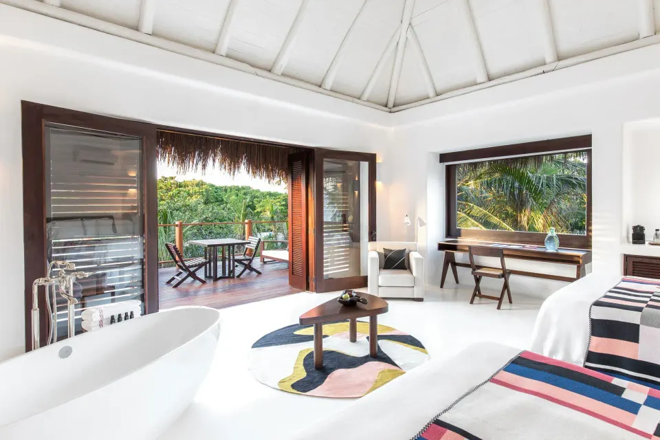 Jungle Suite interior with freestanding tub and terrace access at Hotel Esencia