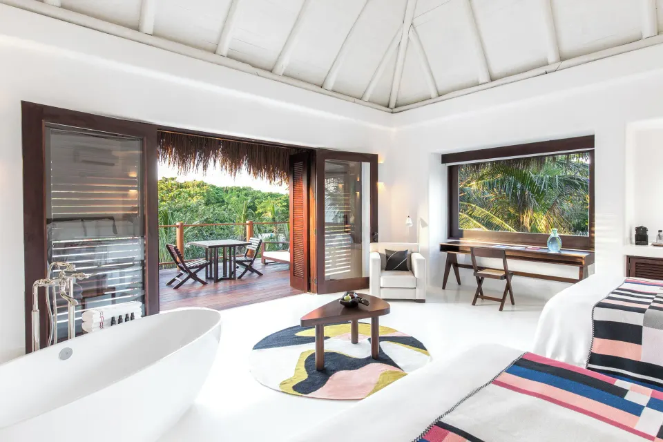 Jungle Suite bright interior with freestanding tub and open terrace doors at Hotel Esencia
