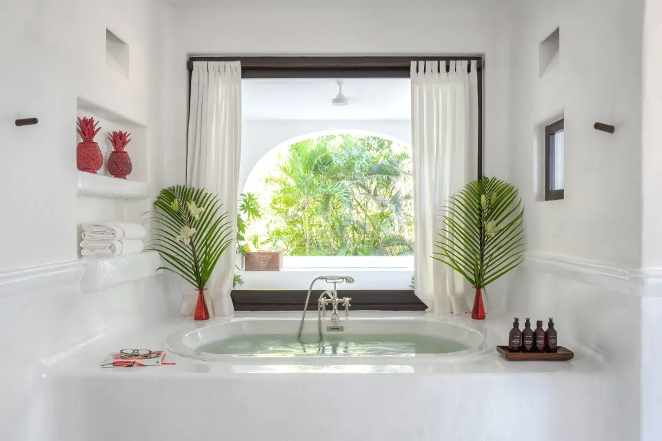 Built-in bathtub with arched jungle view in the Master Jungle Suite at Hotel Esencia