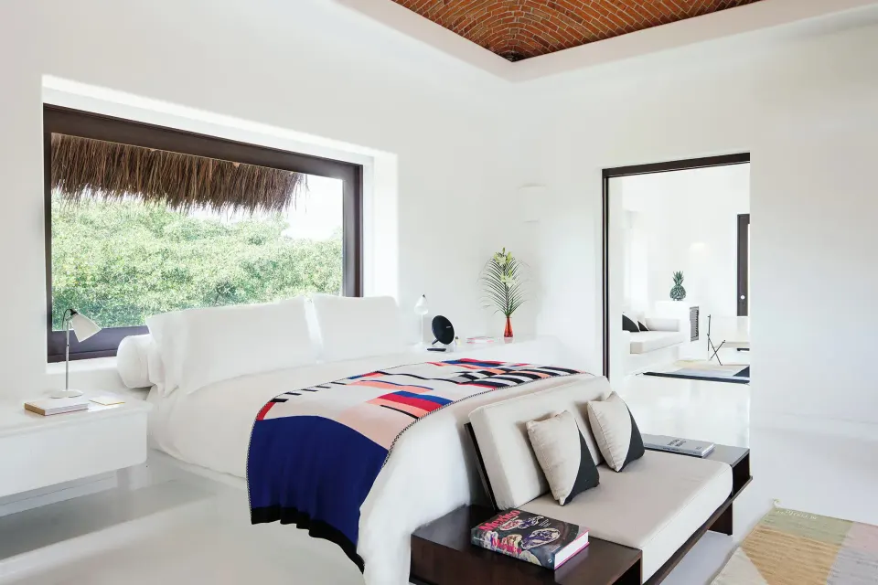 Master Jungle Suite bedroom with king bed and garden view at Hotel Esencia