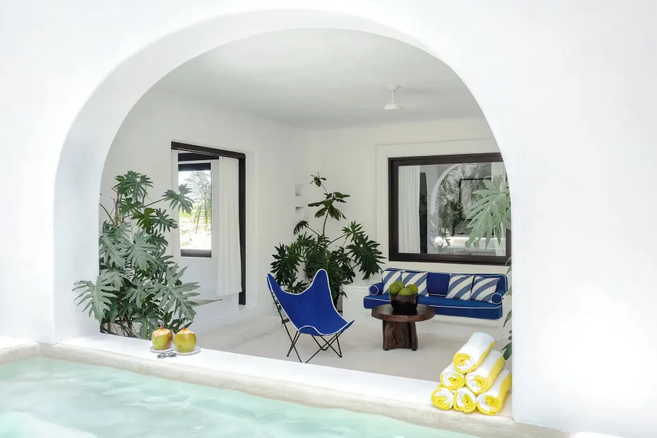 Seating area seen through an arch from the plunge pool in the Master Jungle Suite at Hotel Esencia