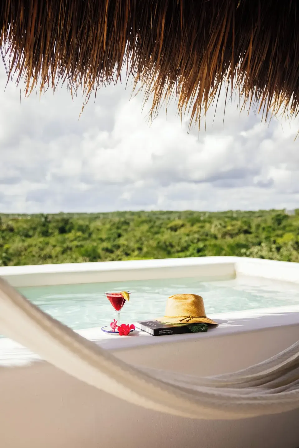 Private plunge pool with hat and cocktail on the Rooftop Wellness Suite at Hotel Esencia