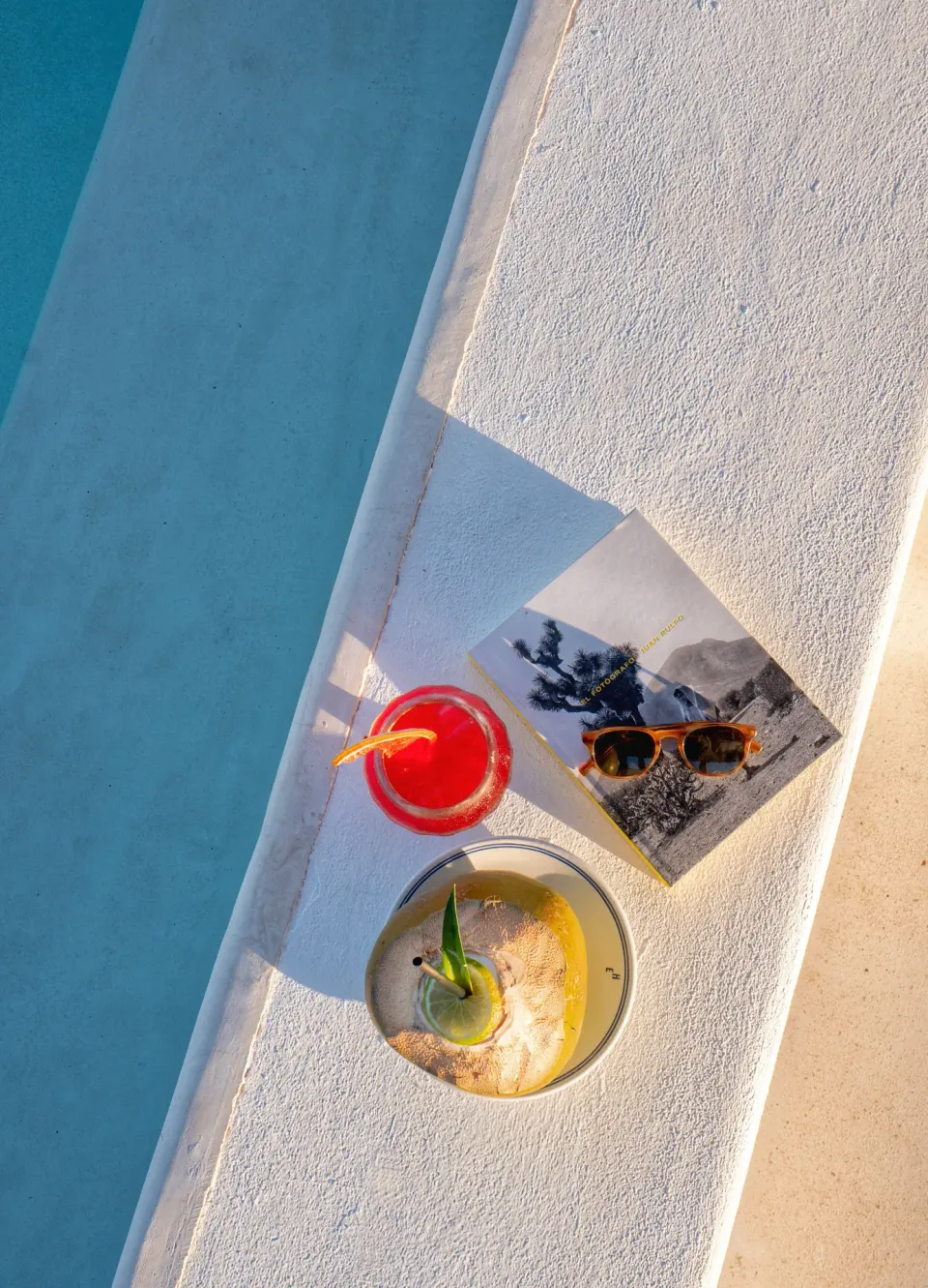 Two drinks and sunglasses on the pool edge at Hotel Esencia