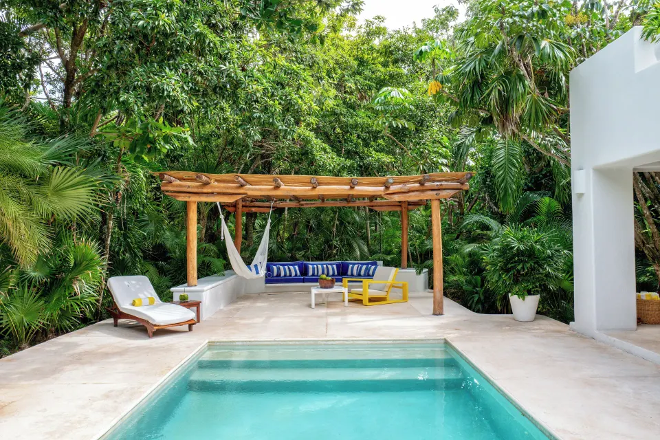 Private pool with pergola seating and hammock at Hotel Esencia