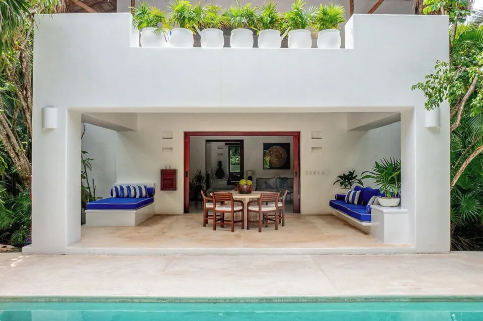 Covered villa terrace opening onto a private pool at Hotel Esencia.