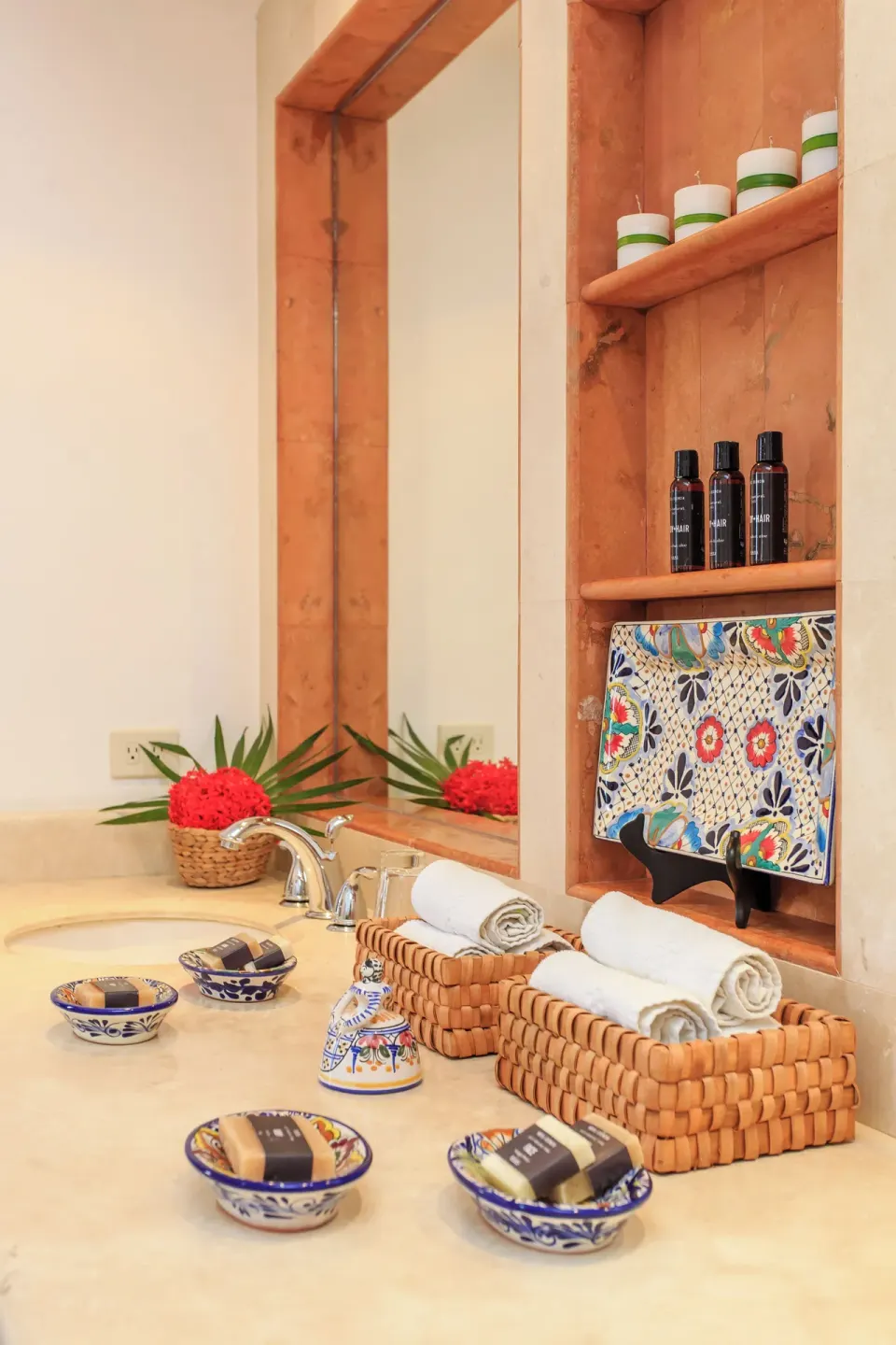 Close-up of folded towels and artisanal bath amenities on a villa sink at Yum-Ha, Hotel Esencia.