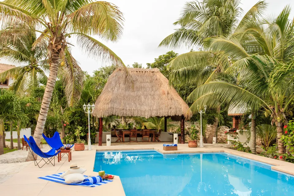 Private pool with palapa and lounge chairs at Yum-Ha Private Villa, Hotel Esencia.