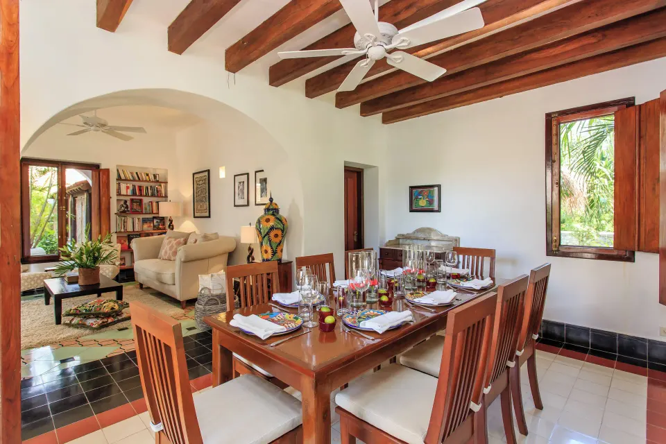 Interior dining area and living space in Yum-Ha Private Villa at Hotel Esencia set for a meal.