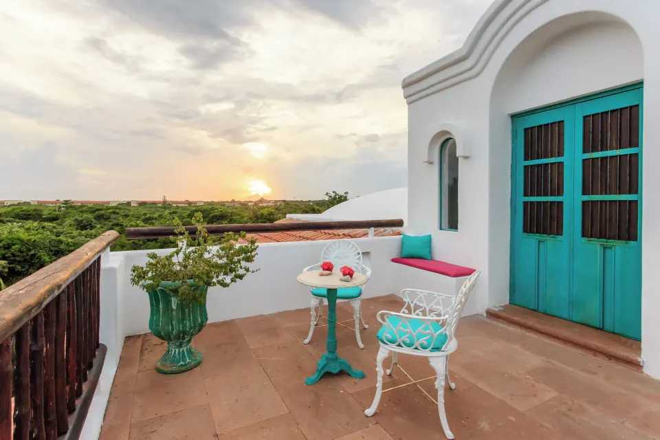 Rooftop terrace with small bistro table and sunset view at Yum-Ha Villa, Hotel Esencia.