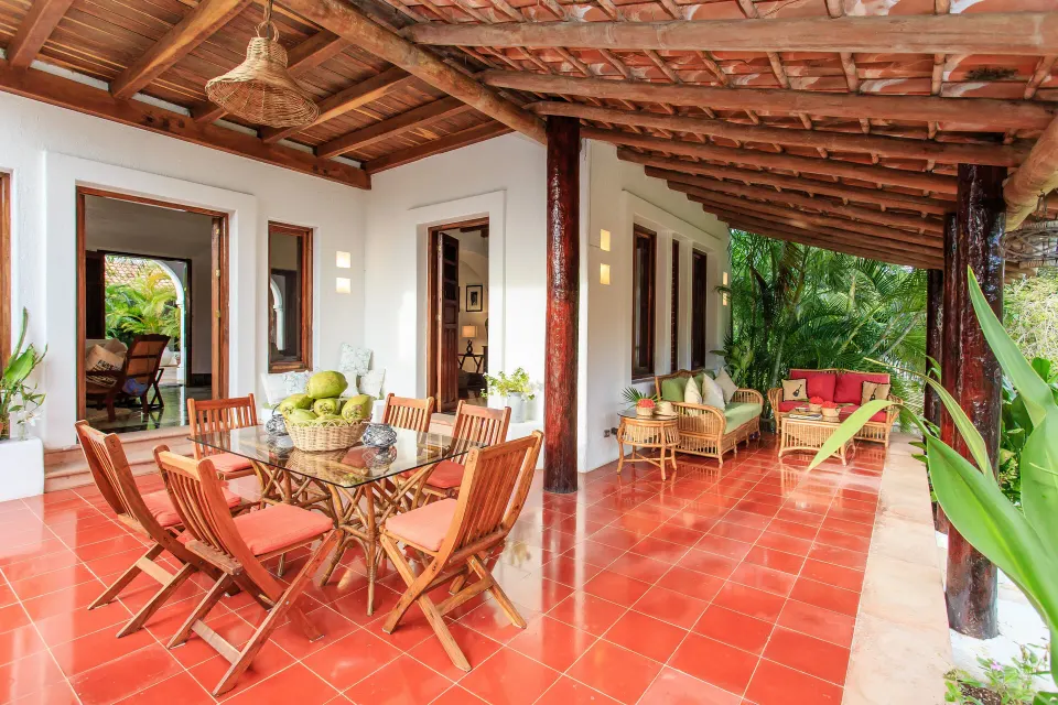 Spacious tiled veranda at Yum-Ha Private Villa, Hotel Esencia with dining table and seating.