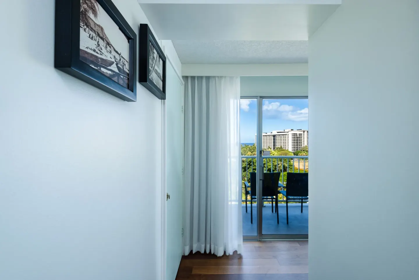 Guest room hallway leading to a balcony with city views at Hotel La Croix.