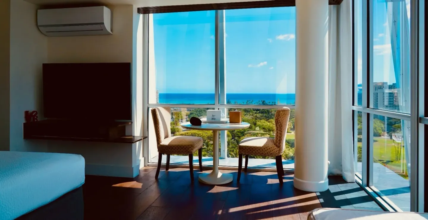 Guest room sitting area with ocean-view windows at Hotel La Croix.