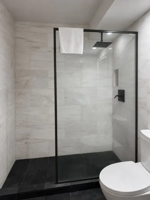 Ali'i Waikiki Two glass shower with black fixtures at Hotel La Croix.