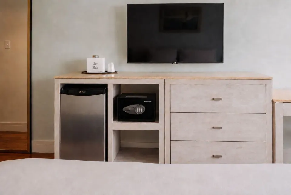 TV, dresser, mini fridge, and safe in Ali'i Waikiki Two at Hotel La Croix.