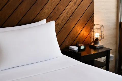 Penthouse Hoku Skyline Honolulu bed and bedside lamp at Hotel La Croix.