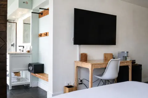Penthouse Hoku Terrace Oceanview room with desk, TV, vanity, safe, and bed at Hotel La Croix.