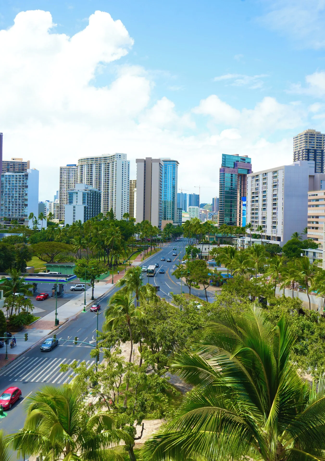 City and palm-lined street view from a Premium Kalakaua Haus room at Hotel La Croix.